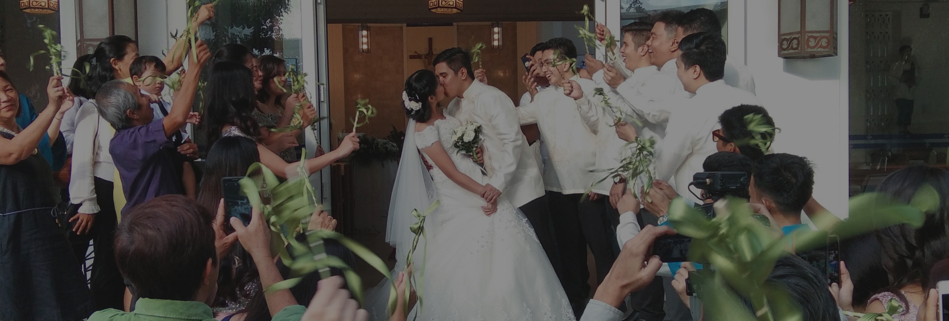 newly married couple surrounded by friends and family